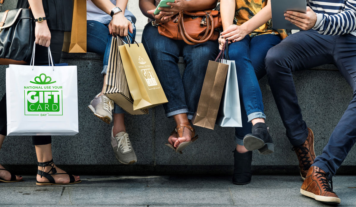 National Use Your Gift Card Day Image With People Sitting Down