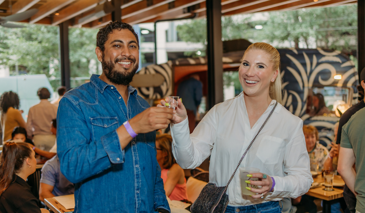 Two People Smiling With A Drink At A Restaurant