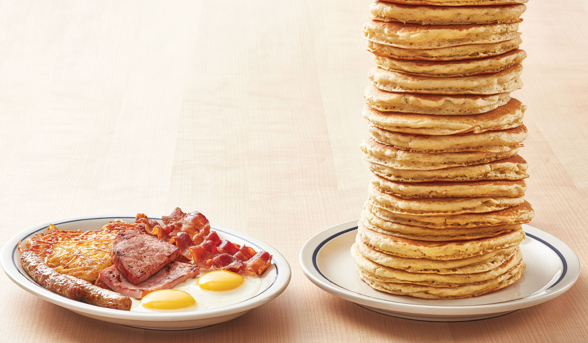 Stack Of IHOP Pancakes Next To Breakfast Plate