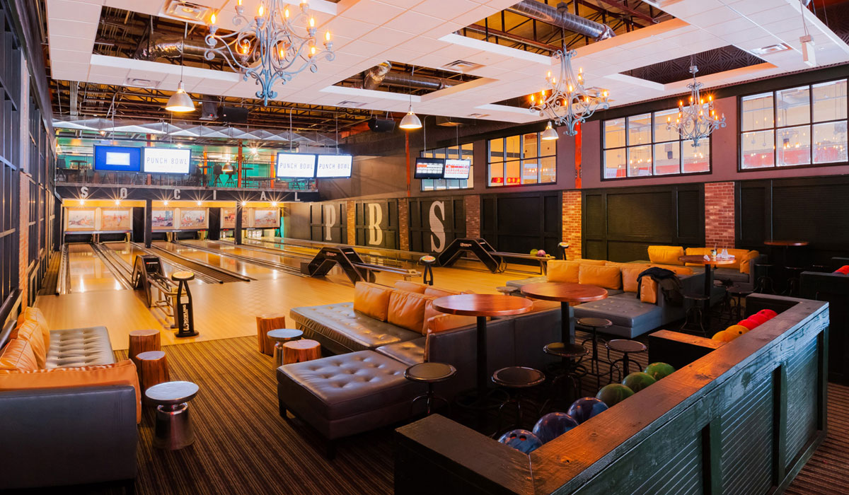 Inside A Punch Bowl Social Restaurant, With Bowling Lanes And Couches