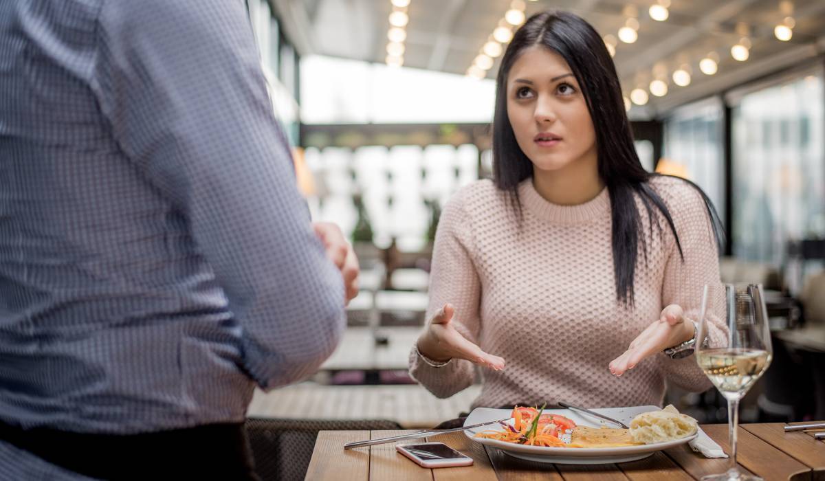 Woman Complaining About Food At Restaurant To Waiter