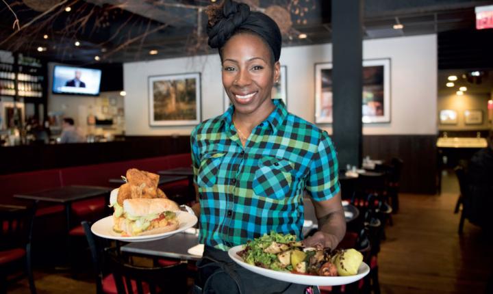 A Waitress Carries Two Plates Of Food