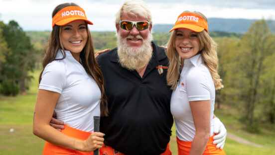 John Daly with two Hooters girls.