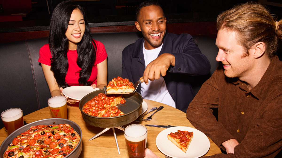 Customers enjoying pizza at BJ's.