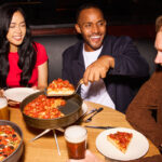 Customers enjoying pizza at BJ's.