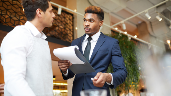 Stock image restaurant manager and employee.