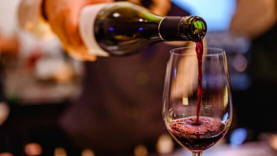 Red wine being poured in a glass.