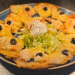 Chi-Chi's Seafood Nachos_ Crisp tortilla chips are loaded with crab, shrimp, creamy seafood sauce, cheddar cheese, sour cream and black olives for a shareable appetizer packed with coastal flavor.